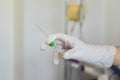 Peripheral venous catheter in the hand of a nurse in the infirmary