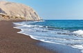 Perissa beach with black volcanic sand on the east coast of the Greek island of Santorini Royalty Free Stock Photo