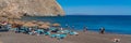 Perissa black beach in Santorini with people in vacation