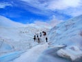 Perito Moreno, March 2022: Panoramic view of the Perito Moreno glacier with a group of climbers walking on the ice. Trekking,