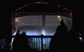 Periwinkle Blue Picket Fence highlights a garden gazebo illuminated at night