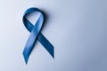 Periwinkle blue ribbon awareness with color bow on woman's hand for stomach and small intestine cancer, esophageal