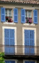 Periwinkle Blue Shutters, Bright Pink and Red Geranimums of a Provencal Home