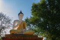 Sunlight from back. The large statuary Buddha is enshrined in the outdoors.