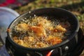 Perkedel jagung or bakwan jagung, corn fritters that is in fry in Portable stove. Indonesian cuisine