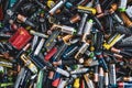 Background - old used discarded AA cells and other electric batteries