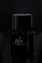 Perm, Russia, February 10 2021: Photo of a dark bottle of Burberry men`s perfume on a dark background. Close up.