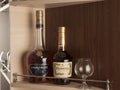Perm, RUSSIA, January 2021. Bottle of Hennessy and Courvoisier vsop on shelf in bar, brown background.