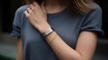 Permanent jewelry wristband with a minimalist metal design on a woman wrist