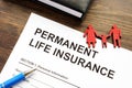 Permanent life insurance application and family figurine. Royalty Free Stock Photo