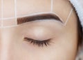 Permanent make-up for eyebrows of beautiful woman with thick brows