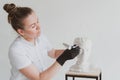 Permanent make-up master, make-up artist, cosmetologist trains permanent make-up using a tool on a plaster head