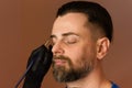 Tinting brows. Handsome man with eyebrows in barber shop. Royalty Free Stock Photo