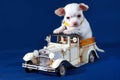 Permissible Luxury - White Chihuahua puppy on a toy car