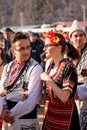 In Bulgarian folk costumes and looking each other