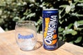 Orangina orange lemonade logo sign and brand text on metal can with empty soda glass