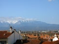 Perpignan. Panorama top view. Tiled roofs of houses and mountains with snowy peaks in the distance. Spring. 2009. France.