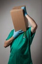 Perplexed doctor with cardboard box head Royalty Free Stock Photo