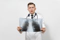 Perplexed focused doctor man with X-ray of lungs, fluorography, roentgen isolated on white background. Male doctor in