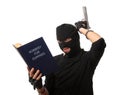Perplexed robber with gun reads book over white. Royalty Free Stock Photo