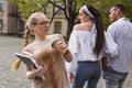 Perplexed student spilling coffee on her shirt