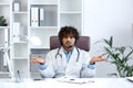 Perplexed young male doctor in medical office displaying uncertainty Royalty Free Stock Photo