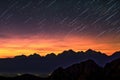 perseid meteors over silhouetted mountain range