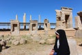 An Iranian girl in front of the ruins of Persepolis