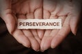 Perseverance text on hand