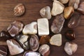 Persian agate heap up stones texture on brown varnished wood background