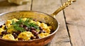 Persian breakfast with eggs, bean and dill in copper pan Royalty Free Stock Photo