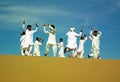 Persian folk dancers on sand dune in a festival in Eastern Iran