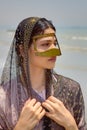 Persian girl in traditional islamic mask of southern Iran, portrait.