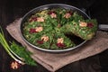 Persian Mixed herbs frittata with barberry and walnut in pan Kuku and Zereshk