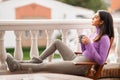 Persian woman on her balcony having a mug of coffee