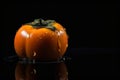 Persimmon on black background Royalty Free Stock Photo