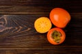 Persimmon on dark wooden background