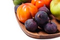 Persimmon and figs on a wooden tray on white Royalty Free Stock Photo