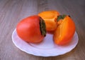 persimmon fruit, close ripe fruits on a plate