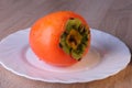 Persimmon fruit, close ripe fruits on a plate