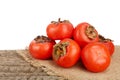 Persimmon fruit on an old wooden table with white background Royalty Free Stock Photo