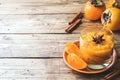 Persimmon fruit smoothie with cinnamon and anise stars, wooden table copy space