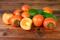 Persimmon. Kaki fruits on old wooden background