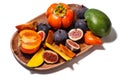 Persimmon, mango and figs on a wooden tray top view isolated on white Royalty Free Stock Photo