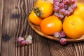 Persimmon. Orange. Grapes. Ripe, sweet fruit