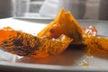 Persimmon peel opened in a dish