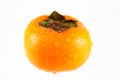 Persimmon splashed with water drops Royalty Free Stock Photo