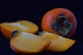 Persimmons on a black background Royalty Free Stock Photo