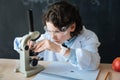 Persistent little scientist taking part in microbiology experiment at school