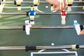 A person is actively engaged in playing a game of foosball on a table Royalty Free Stock Photo